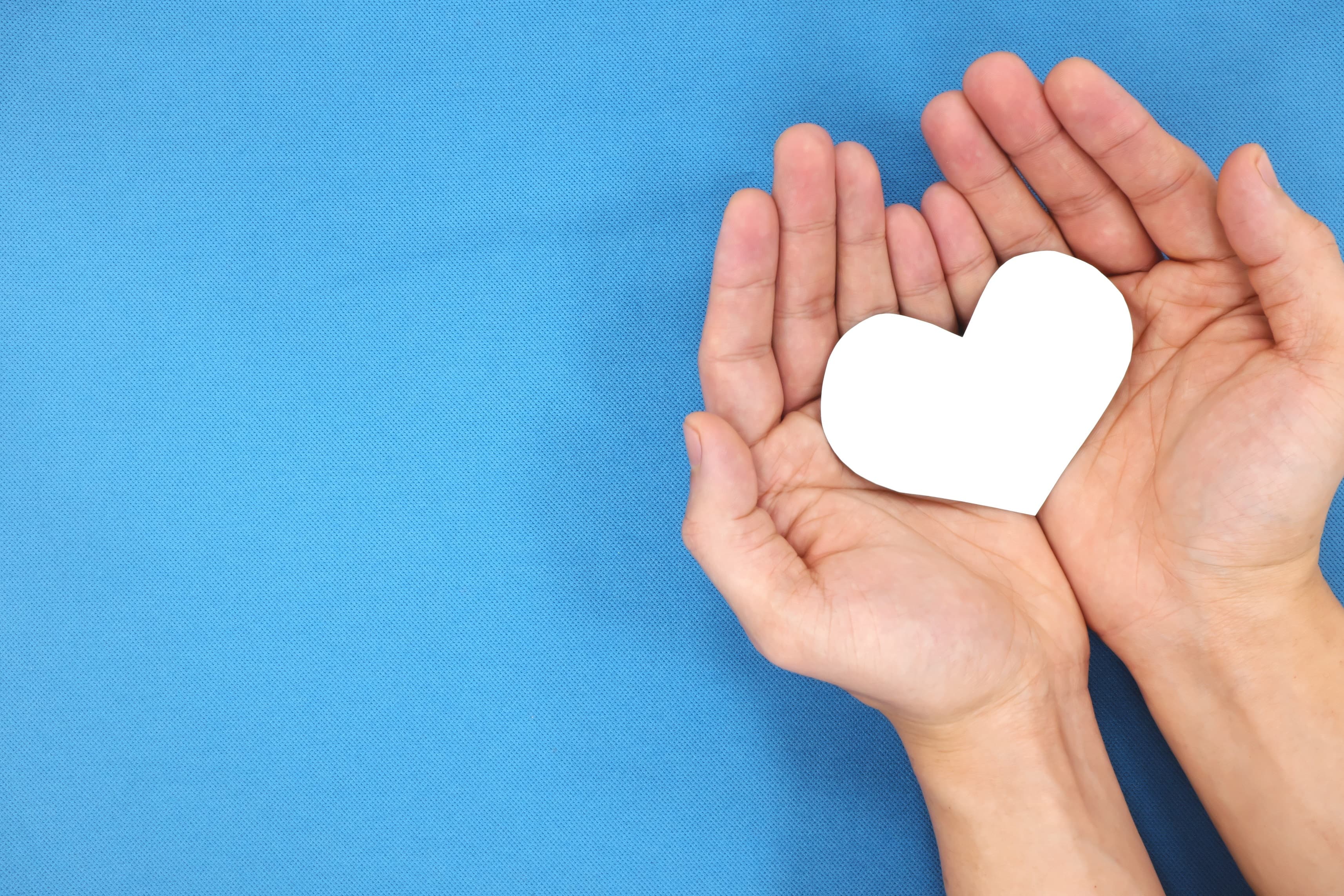 An image of a hand holding a heart